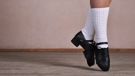 Tap dancer legs dancing on a plywood dance floor (closeup)