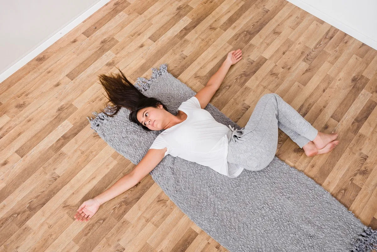 Woman in Yoga pose on the wood floor