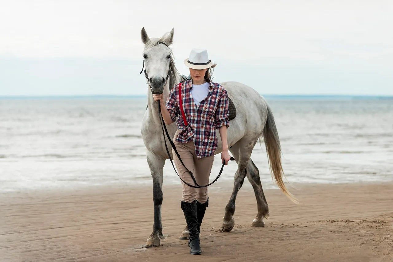 Woman and a horse. Lake in background.