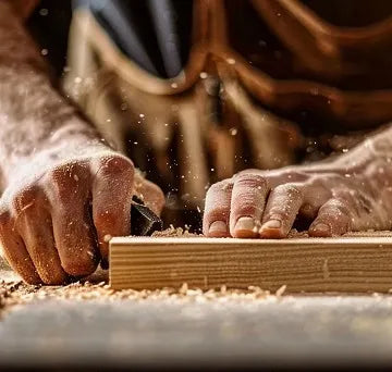 Carpenter's hands with a cutting tool 