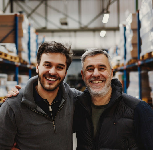 Two smiling men in a warehouse